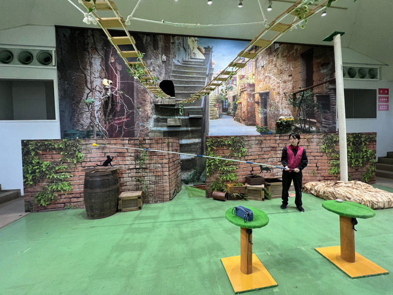 先端にボールがついた釣りざおを持つ飼育員の橋本さんの写真